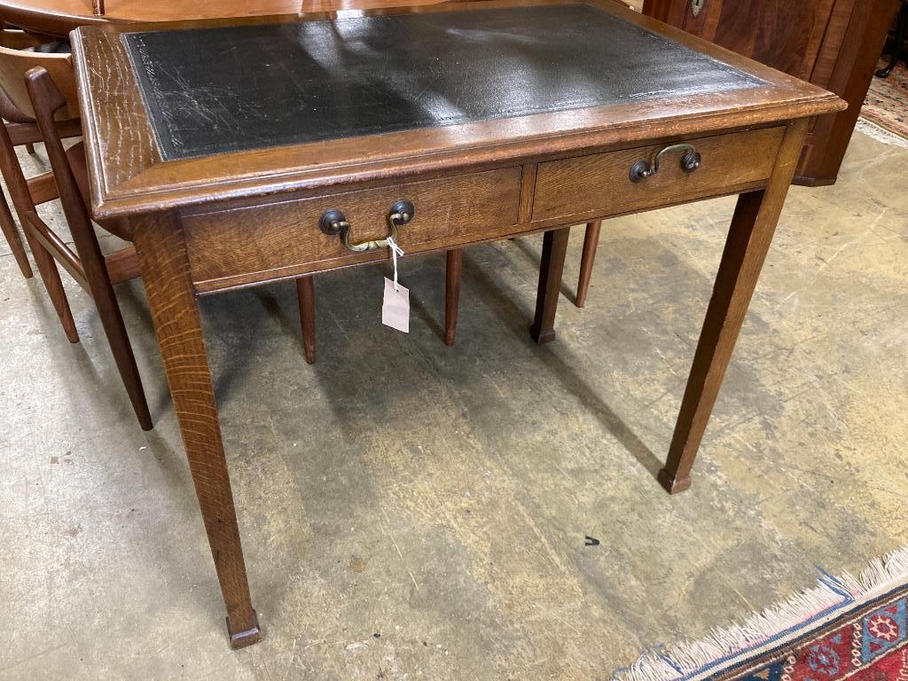 A 1920's oak writing table, width 91cm, depth 60cm, height 76cm